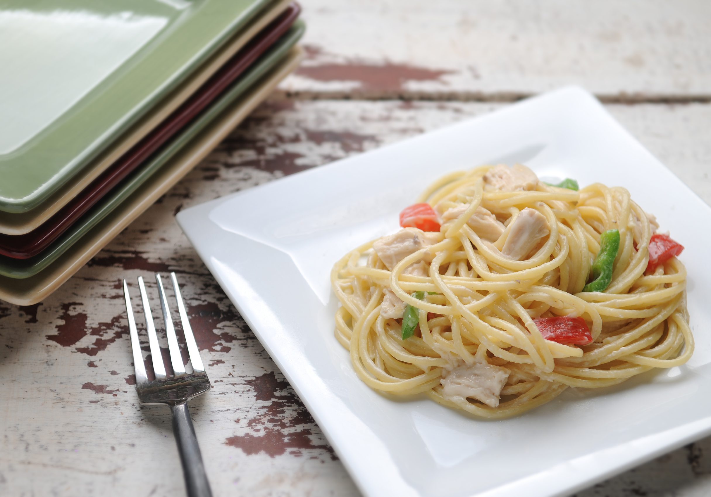 Peppers, chicken, and spaghetti coated in a creamy sauce