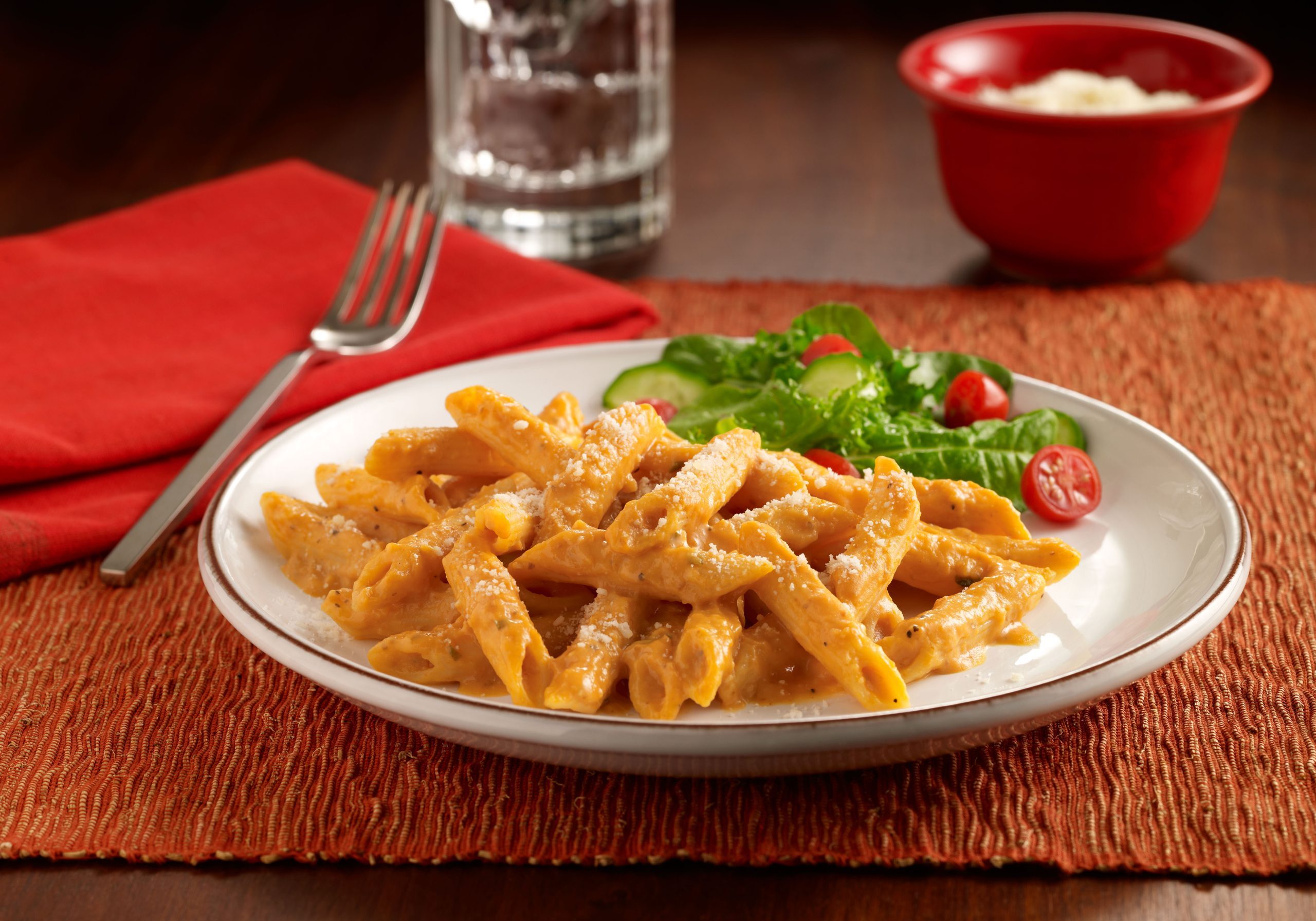 Penne pasta coated in a creamy pumpkin sauce