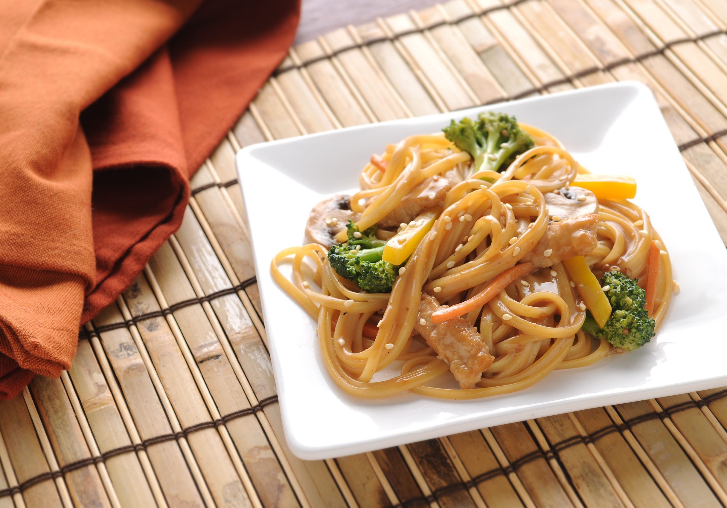 Linguine, pork, carrots, and broccoli coated in an Asian vinaigrette and topped with sesame seeds