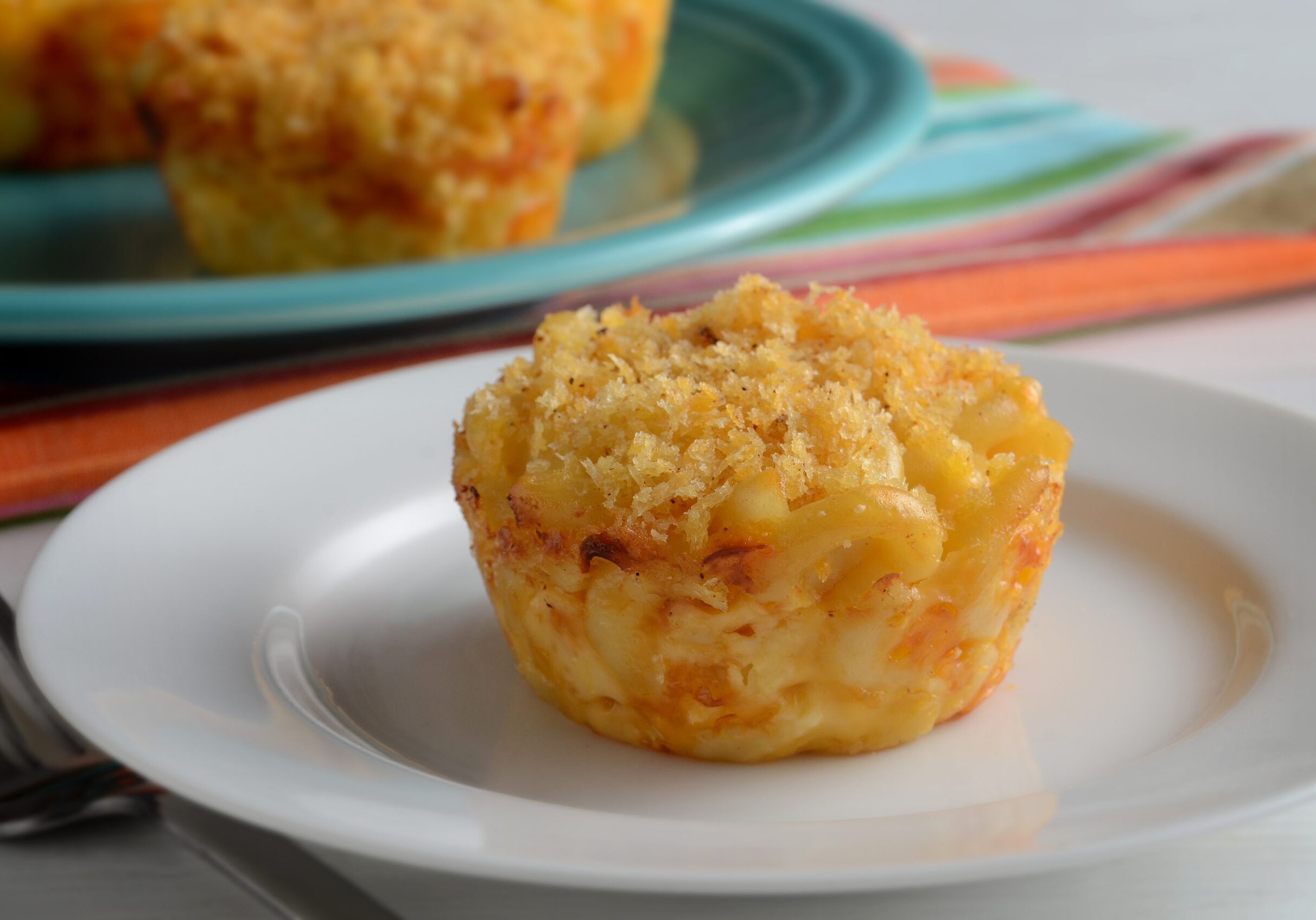 Macaroni and cheese formed into bite-size muffins and sprinkled and baked with panko bread crumbs