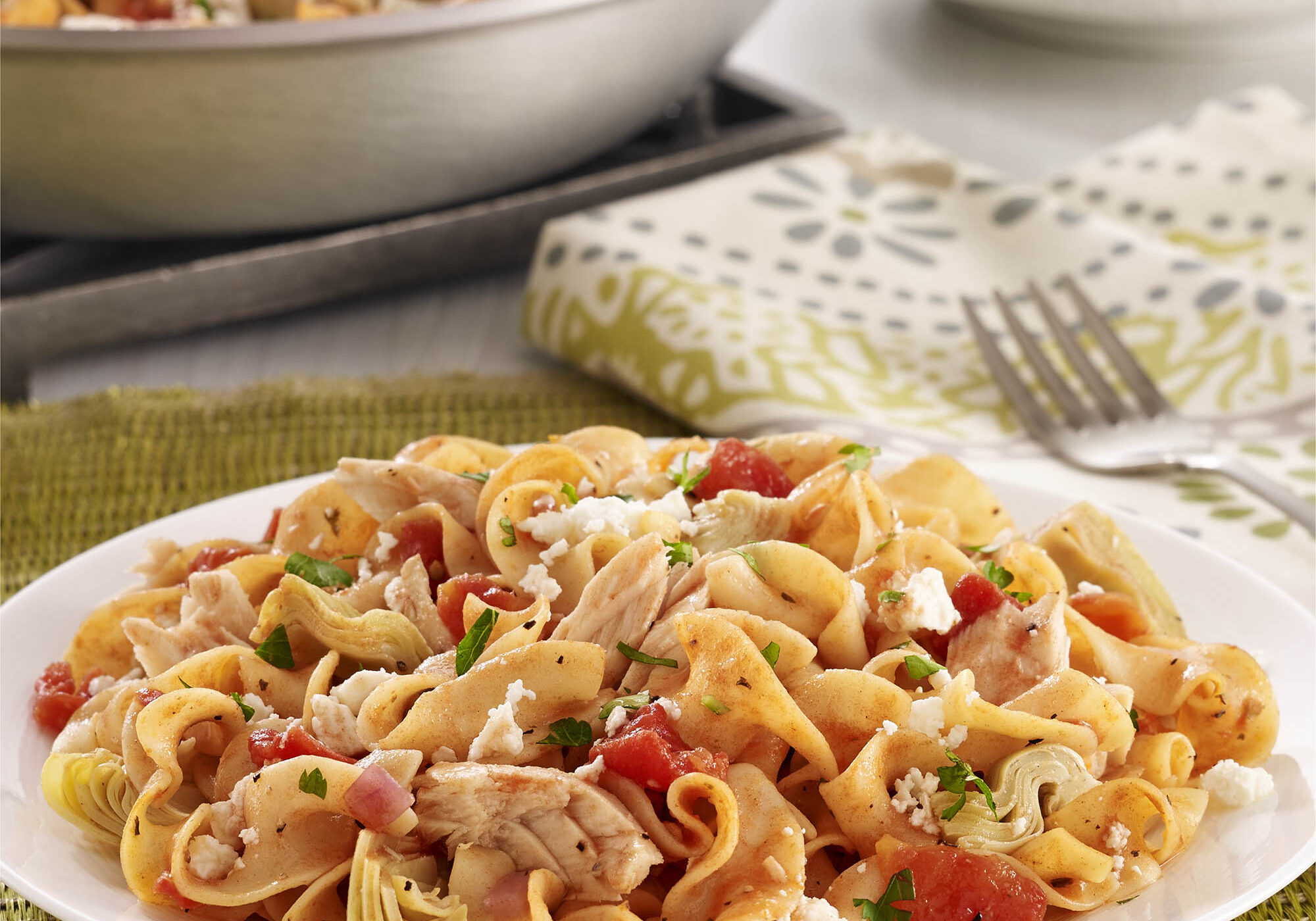 Egg noodles with tuna, artichokes, diced tomatoes, and feta cheese