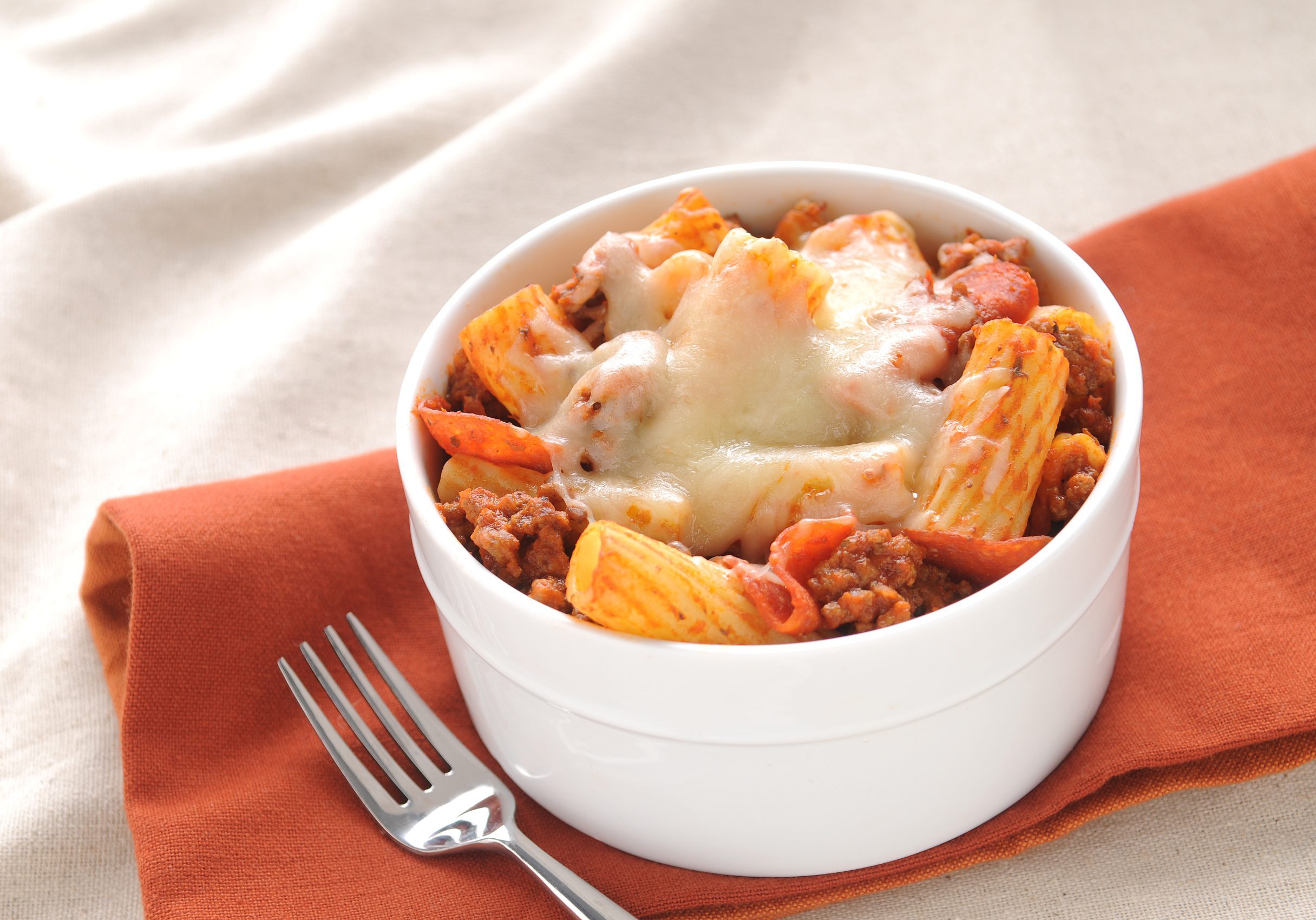 Pizza pasta with rigatoni, Italian sausage, pepperoni, sauce, and cheese