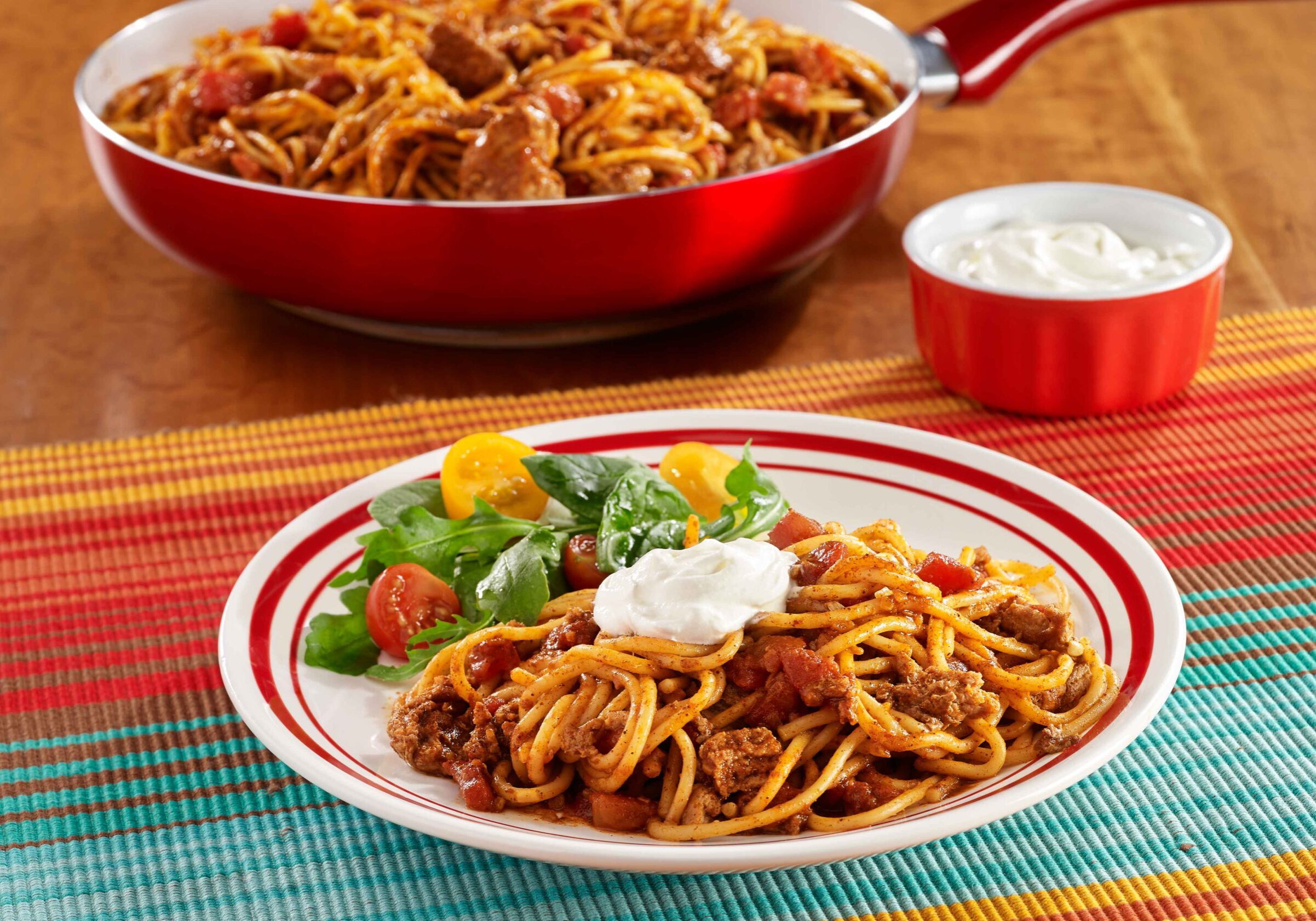 Pot-Sized™ Spaghetti with ground turkey, seasoned tomatoes, and taco seasoning, topped with sour cream
