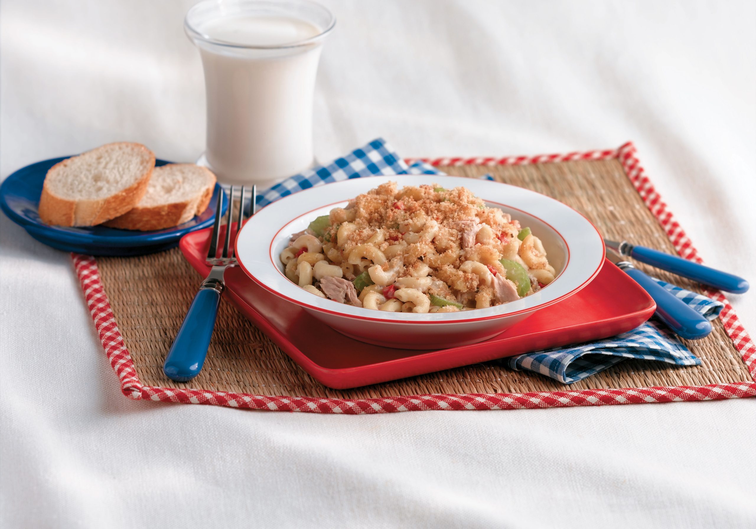 Picnic macaroni salad with elbows, celery, and green peppers, topped with bread crumbs