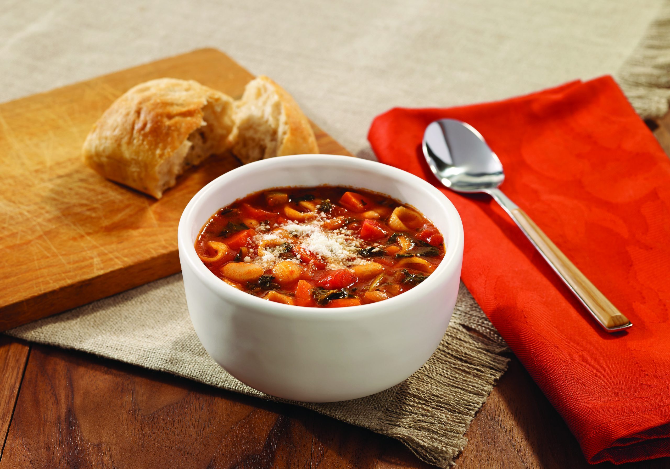 Minestrone soup with shells, vegetables, white beans, and kale