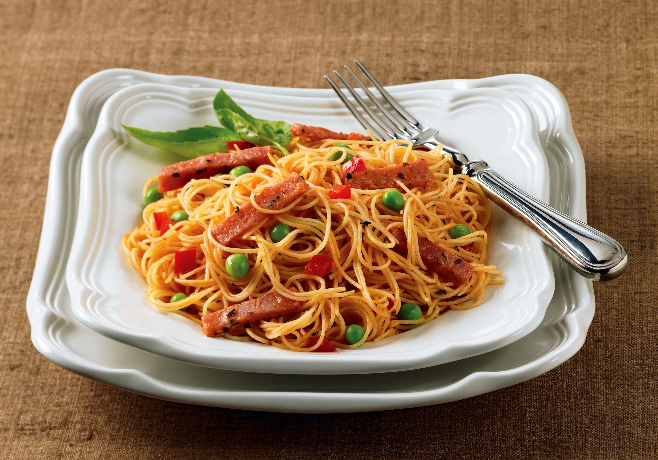 Angel hair pasta with ham and fresh vegetables in a light sauce